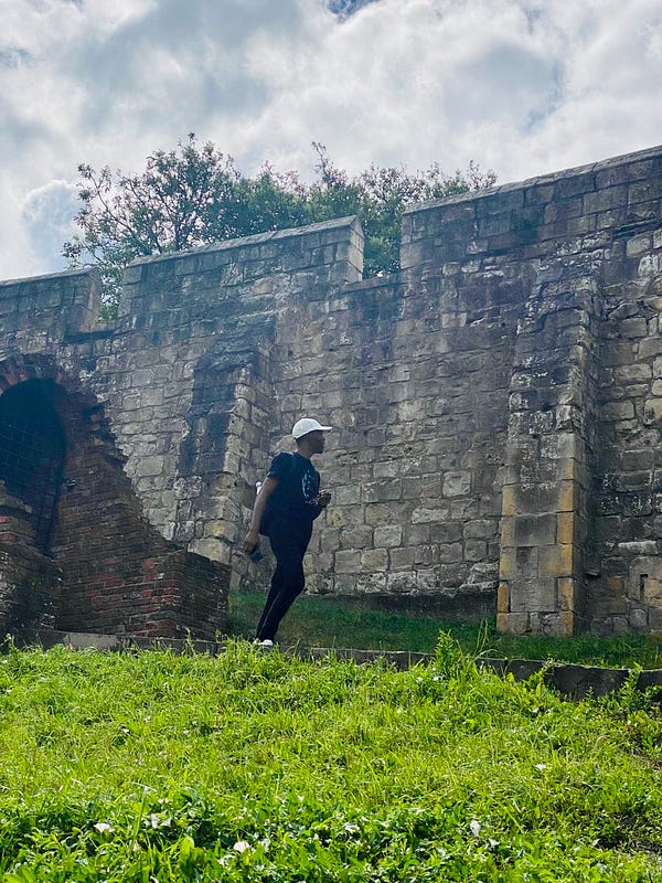 David walking and looking at the Wall of York built in the 1100s to keep the Vikings out.