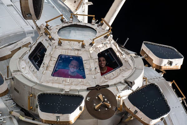 NASA Astronauts Bob Hines and Jessica Watkins look out from the cupola, the International Space Station's "window to the world."