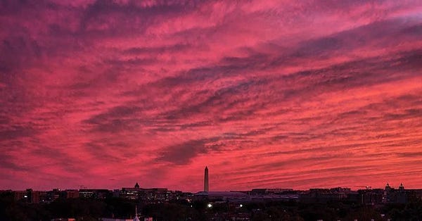 A pink sunset behind the Washington Monument.