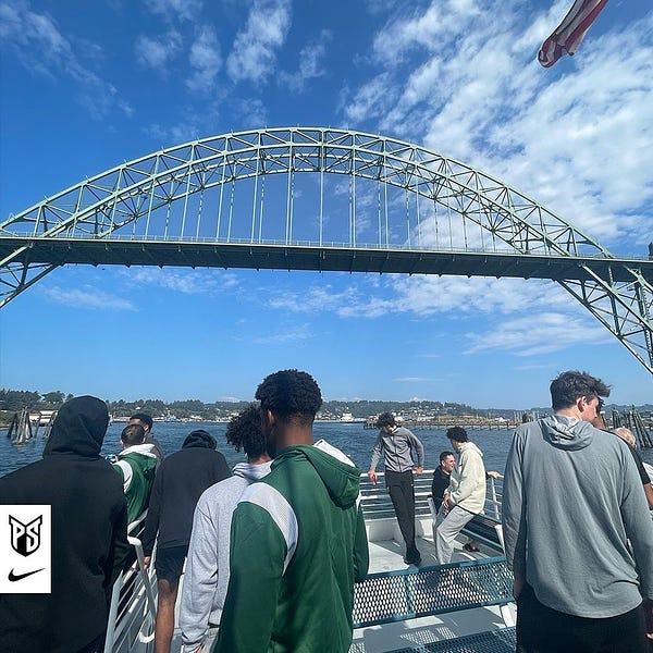 The team on the boat with the Yaquina Bay Bridge in the background in Newport, Oregon.