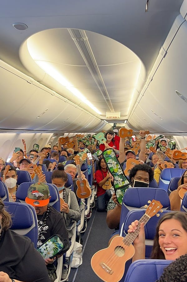 Southwest passengers smiling with their ukeleles.