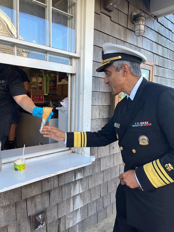 U.S. Surgeon General Vivek Murthy receiving an ice cream cone. 