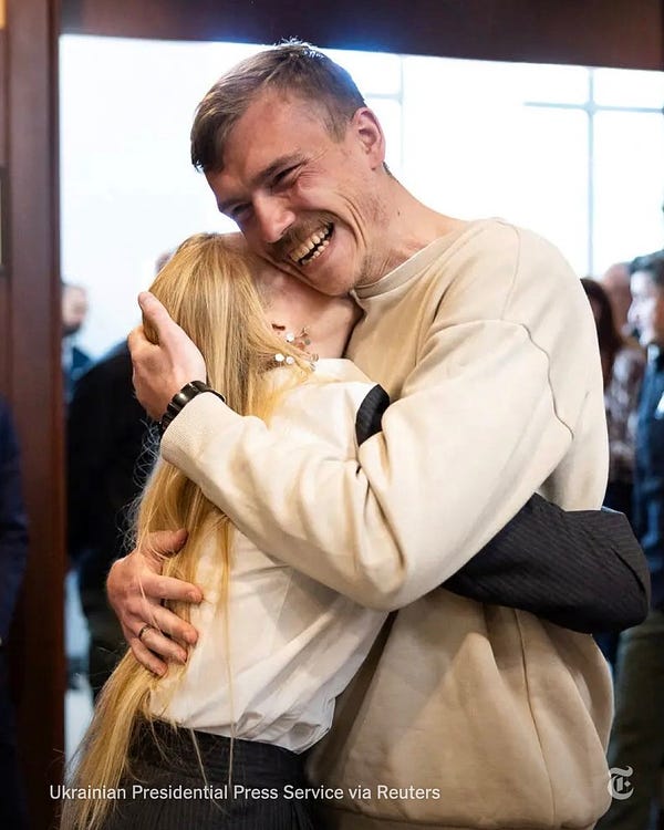 Denys Prokopenko, a commander of Ukraine’s Azov battalion, smiles as he embraces his wife, Kateryna. Photo credit: Ukrainian Presidential Press Service via Reuters