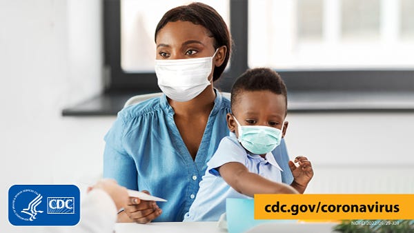Adult with mask holding a young child on her lap who is wearing a mask. Text overlay includes cdc.gov/coronavirus. Graphic is branded with CDC logo.