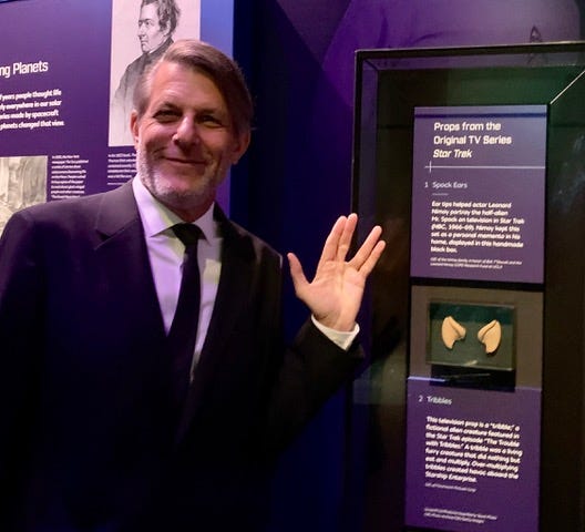 Adam Nimoy gives the "Vulcan Salute" next to the display of his dad Leonard Nimoy's Spock ear tips at the Smithsonian National Air and Space Museum.