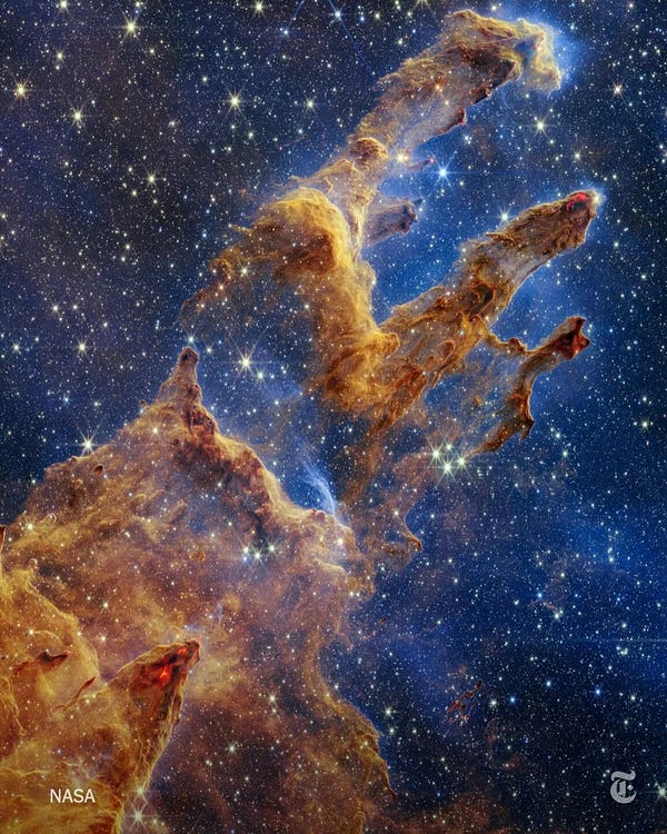 A view of the Pillars of Creation captured by NASA’s James Webb Space Telescope’s near-infrared camera. The pillars of cherry-red streaks and waves resemble arches and spires rising from a desert, but are filled with semitransparent gas and dust.
