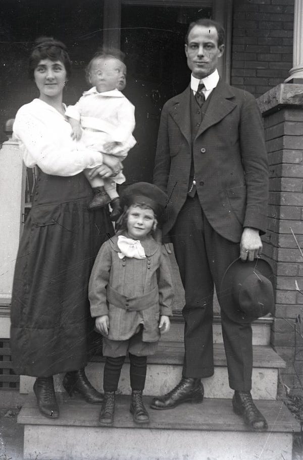 Rae Luckock, her husband Richard Charles Luckock, and their children Warren and Keith (in Rae's arms) on the porch of their home at 527 Crawford Street in Toronto, circa 1920 (F 4725)