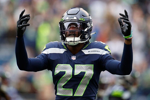 Seattle Seahawks cornerback Tariq Woolen (27) warms up before an