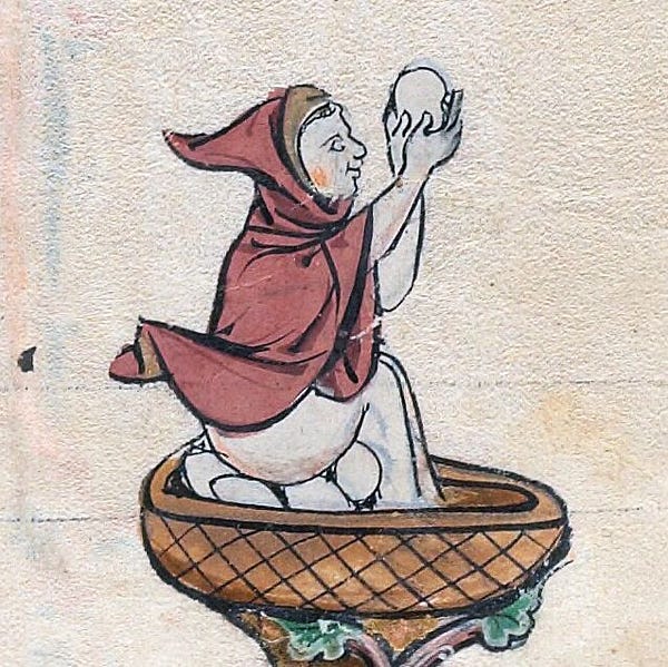 A medieval drawing of a man who is naked except for a short red hooded cape, sitting on a pile of large eggs and holding one up in front of himself
