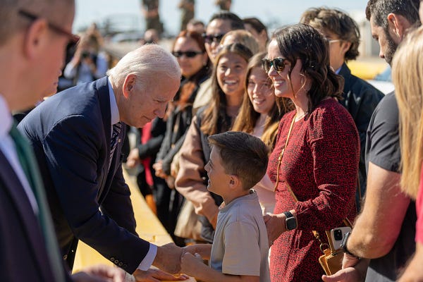 President Biden greets a young event attendee.