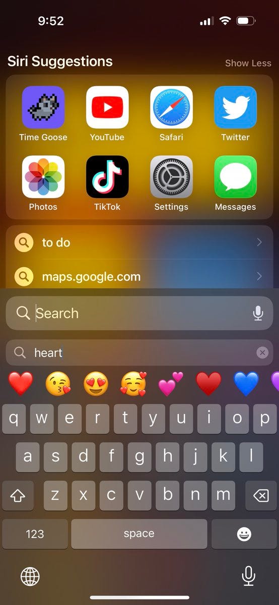 Emoji search keyboard on iOS typing into Spotlight with the query “heart”