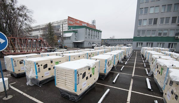 Generators are lined up in a parking lot prior to being delivered to hospitals, schools, emergency services, and government agencies.