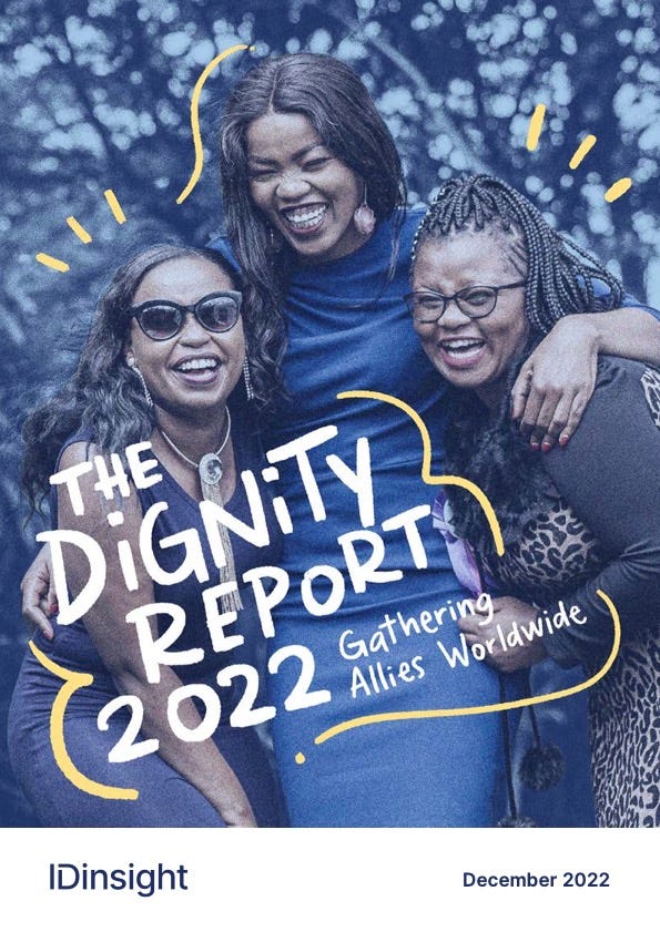 The cover of 'The Dignity Report 2022: Gathering Allies Worldwide' features three young women laughing and hugging on a blue filter, with animated yellow lines communicating their excitement.