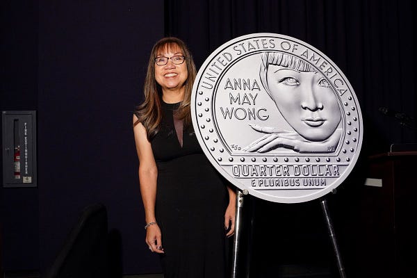 Anna Wong, niece of Anna May Wong, poses with a blowup of the new Anna May Wong quarter.