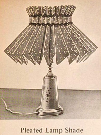 A pleated lamp shade made from punch cards.