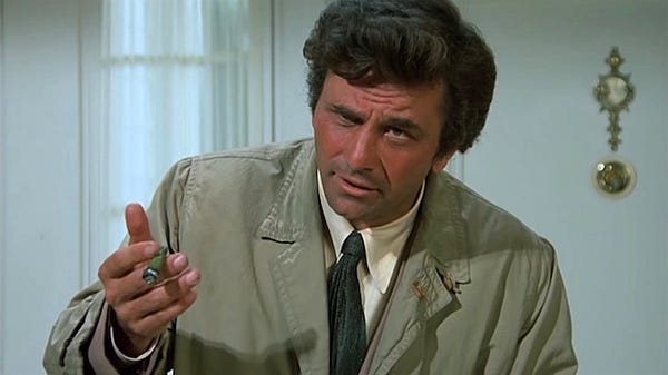 Columbo, holding a cigar, interrogating someone out of frame.