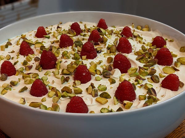 Christmas trifle covered in raspberries and pistachios 