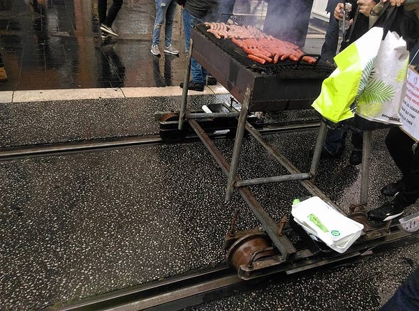 close-up shot of how the barbecue is connected to the tram rails, allowing for easy movement