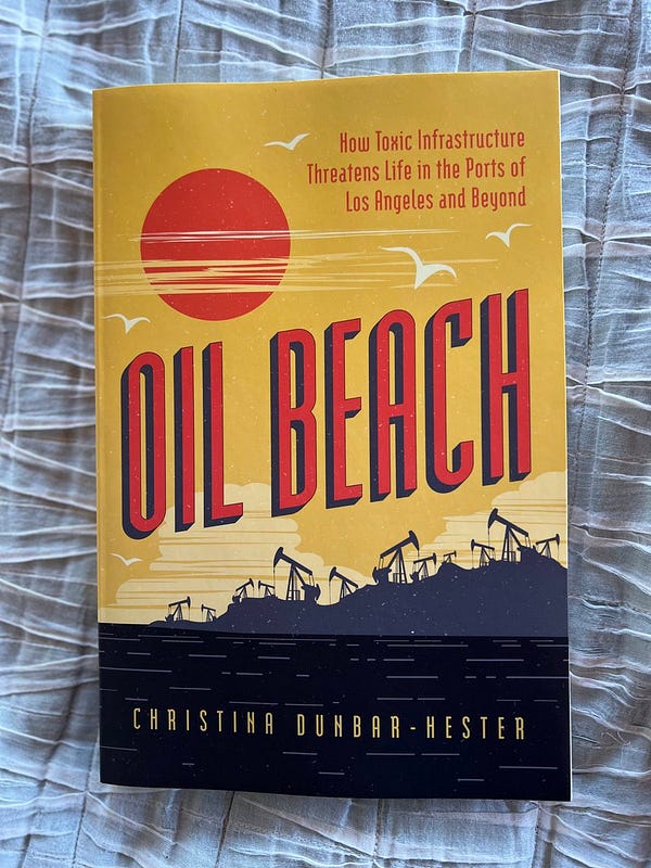 Book cover: yellow toxic sky with orange setting sun and orange lettering reading Oil Beach: How Toxic Infrastructure Threatens Life in the Ports of Los Angeles and Beyond. The sun is setting over a spit of land blanketed by pumpjacks in silhouette, rising above inky black water. A few shadowy white birds fly around the the top of the sky