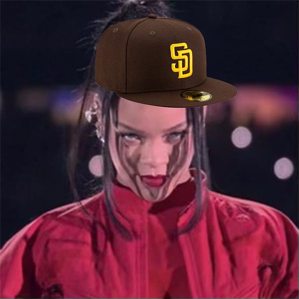 Photo. Rihanna is shown looking at the camera at the start of her Super Bowl performance. A brown Padres hat with a yellow San Diego logo is placed on her head.