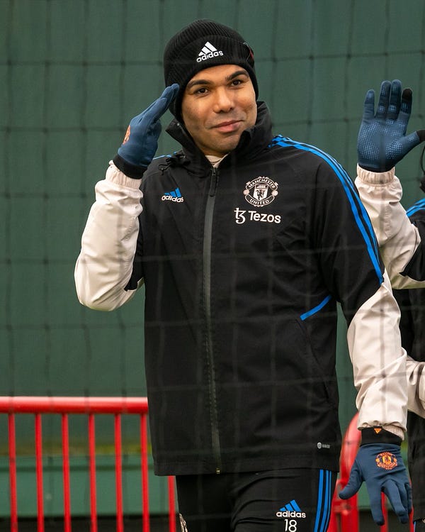 Casemiro salutes the camera as he walks out for training.