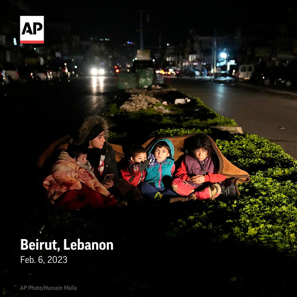 A family who fled the war in Syria and live in Beirut, sit outside their home following an earthquake that hit neighboring Turkey.