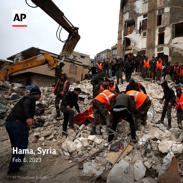 Civil defense workers and security forces search through the wreckage of collapsed buildings in Hama, Syria. 