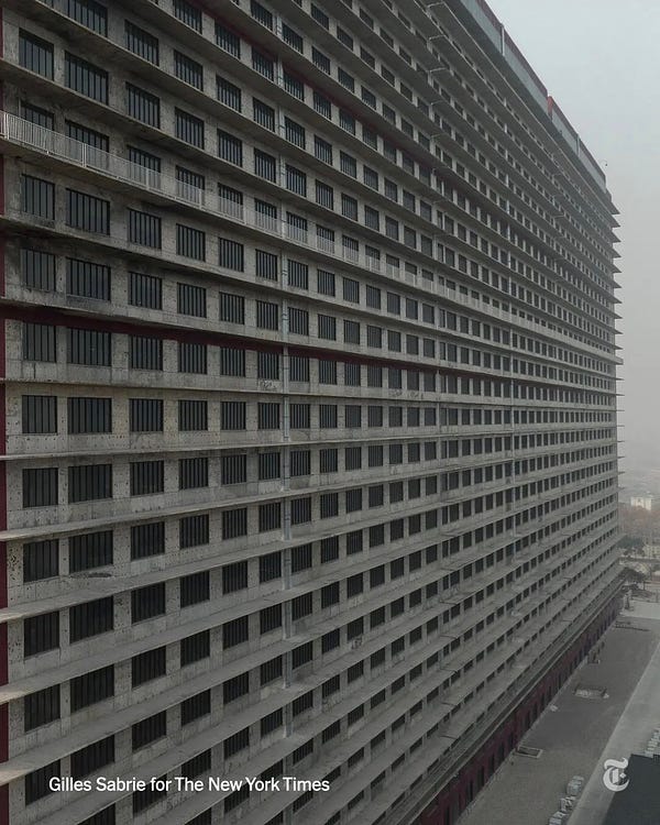 An angled view of a tall tower block located on the outskirts of Ezhou, China. There are 24 floors dedicated to pig breeding and raising. Photo by Gilles Sabrie for The New York Times.