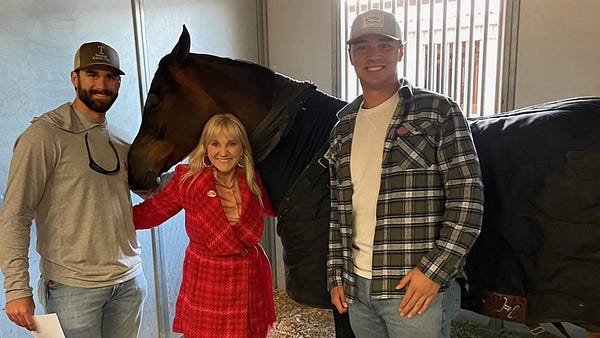 Colorado Rockies prospects Luke Taggart and Gabriel Hughes pose with a horse and its trainer.