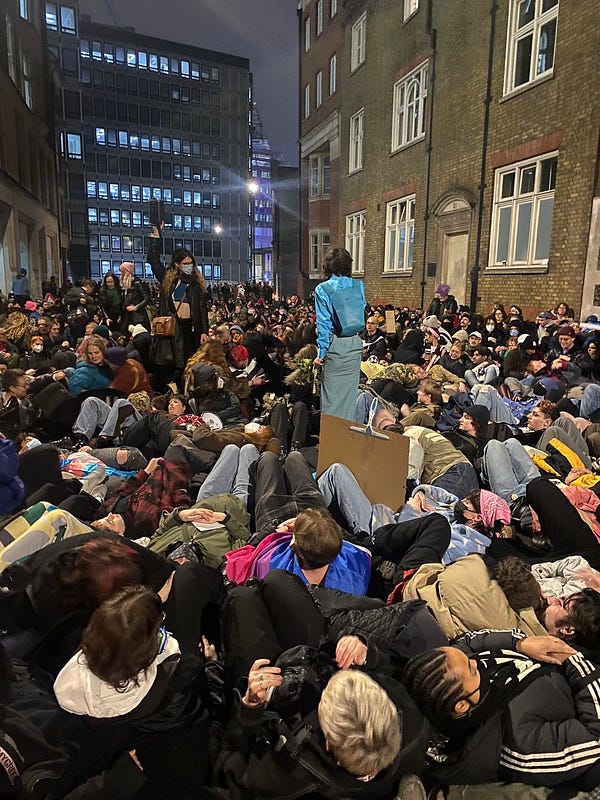 Thousands of young LGBTQ people lying together in the street outside the Department for Education in London, U.K.