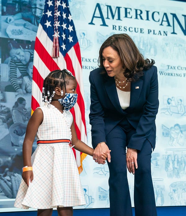 Vice President Kamala Harris speaks with a young girl at the White House. 