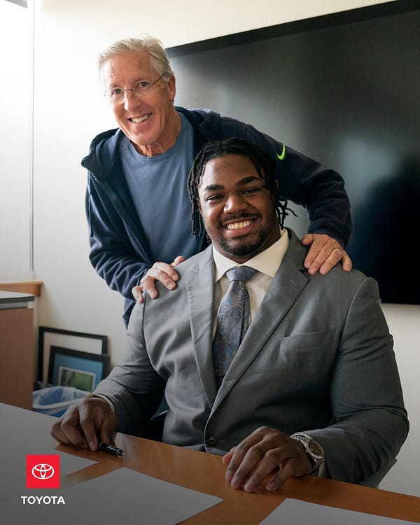 Phil Haynes and Pete Carroll after Haynes signed his contract extension.