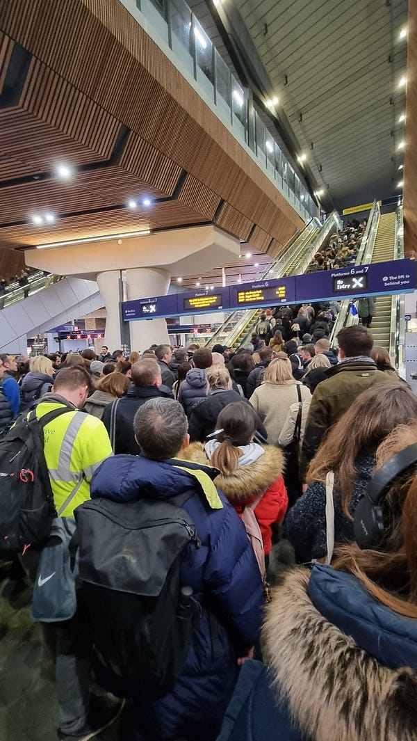 An image showing an overcrowded concourse at London Bridge Station. The image shows a crush as people attempt to get to the platform level. 
