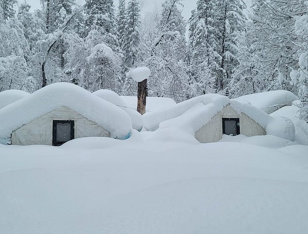 Curry Village tent cabins about half buried in snow with additional snow on the roofs