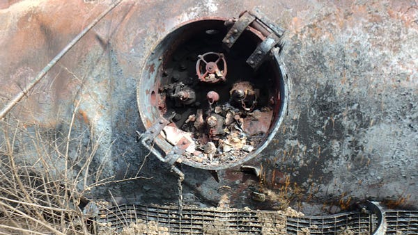 Tank car OCPX80235 with missing aluminum protective housing cover and metallic debris contained within the protective housing.