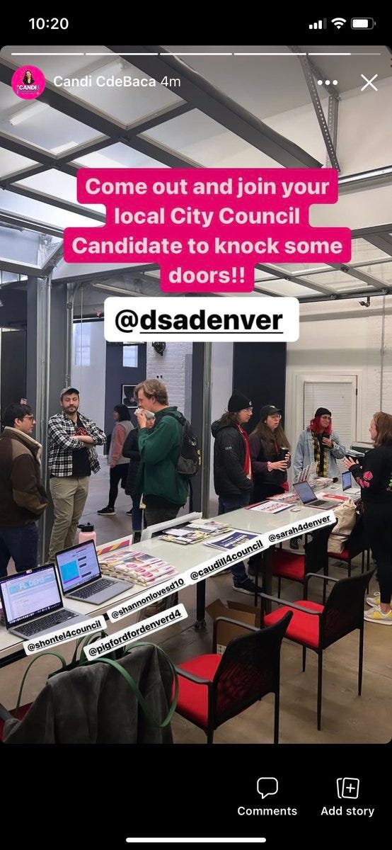 A picture of people in a room talking. A table and a row of chairs is in the foreground, with laptops and papers on it. “Come out and join your local city council candidates to knock some doors!!” DSA Denver is tagged