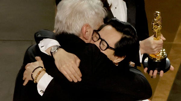 Ke Huy Quan hugging Harrison Ford