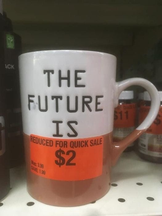 Coffee mug with the text “The future is” and a sticker that says “Reduced for quick sale.”