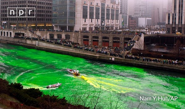 People watch as the Chicago River is dyed green (using an orange powder) on March 13, 2010, as part of the city's celebration of St. Patrick's Day. Nam Y. Huh/AP
