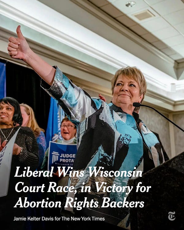Janet Protasiewicz, the liberal candidate in Wisconsin’s Supreme Court election, smiles and gives a thumbs up during her election night party in Milwaukee. Text reads: "Liberal wins Wisconsin court race, in victory for abortion rights backers." Photo by Jamie Kelter Davis for The New York Times.