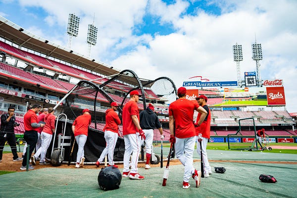Reds players stand around the cage during batting practice ahead of the team's intrasquad scrimmage at GABP.