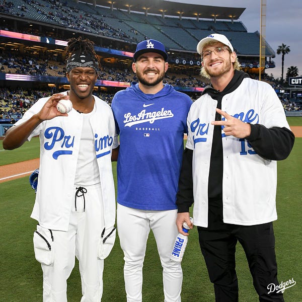 KSI, Alex Vesia and Logan Paul pose for a photo after throwing out the first pitch.