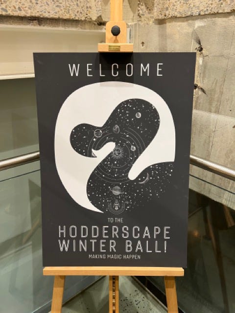 poster for hodderscape winter ball, cocktail menu, picture of red cocktails called vampire's kisses and a group of smiling authors and editors.