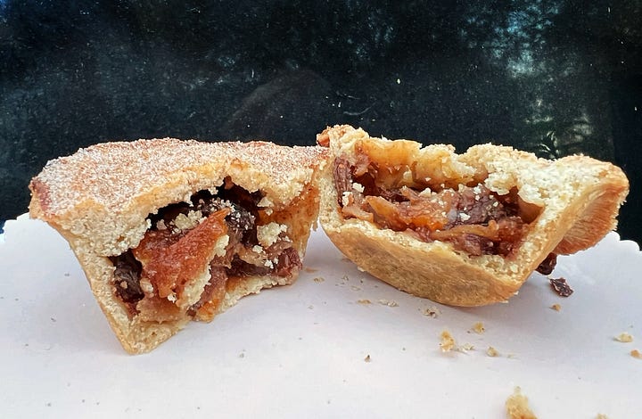 Mince pies by sourdough Sophia. With cinnamon sugar dusting. One is cut to reveal orange peel. 