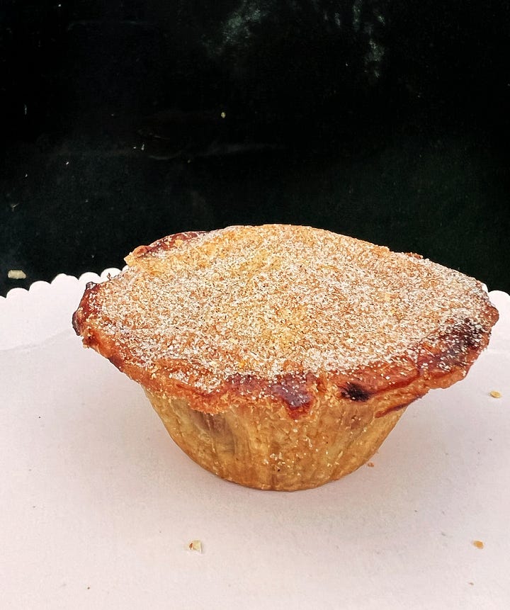 Mince pies by sourdough Sophia. With cinnamon sugar dusting. One is cut to reveal orange peel. 