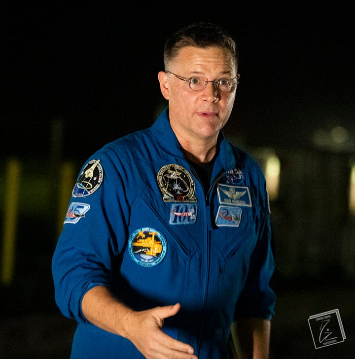 NASA Astronaut Col. Doug "Wheels" Wheelock gestures with his hands while speeking.