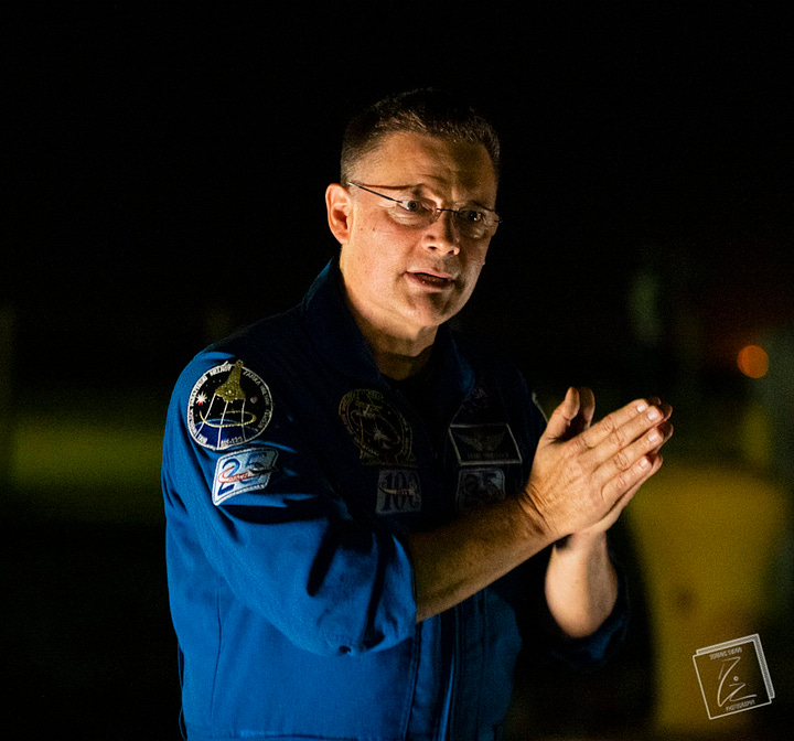 NASA Astronaut Col. Doug "Wheels" Wheelock gestures with his hands while speeking.