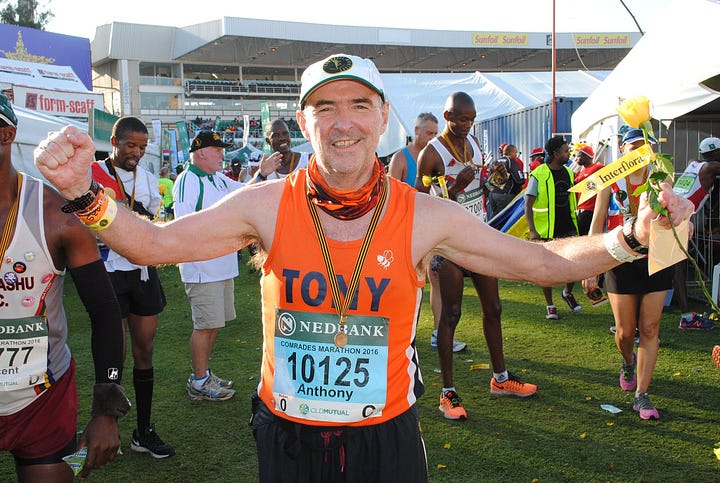 Tony Collier running and his marathon major medals