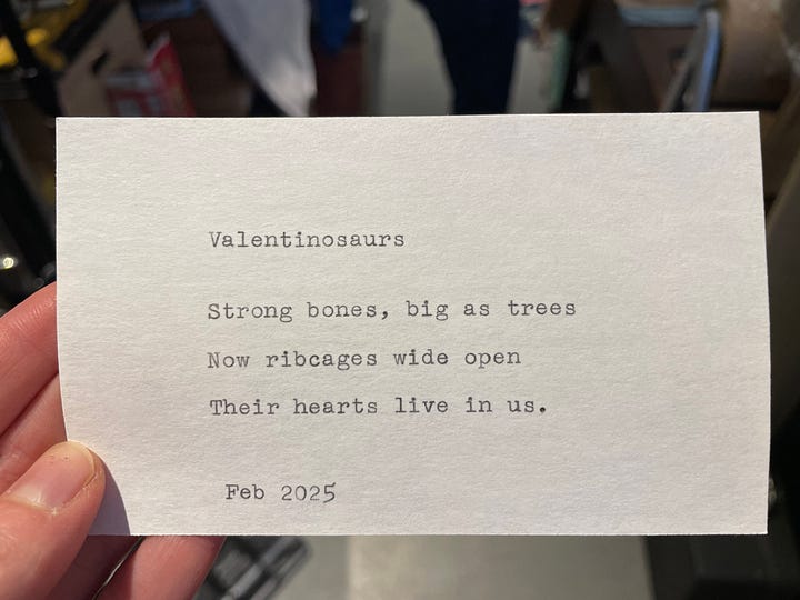 Typewriter set up on a card table in a bookshop and three index cards with haiku on them.