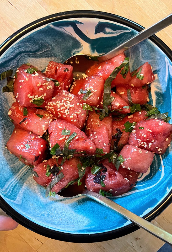 Hand holding peach perilla salad, hand holding watermelon perilla salad